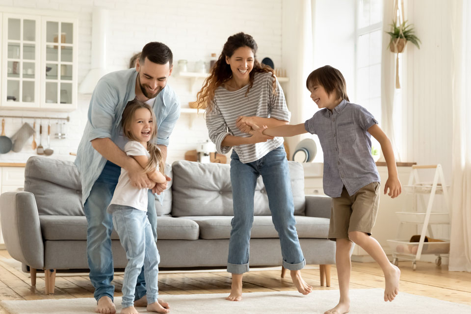 Family dancing in their living room together